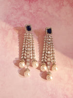 Load image into Gallery viewer, A pair of long, ornate dangle earrings with dark blue stones , and ending in three white pearls,