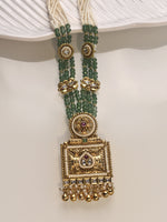 Load image into Gallery viewer, Gold and green beaded necklace on a white surface