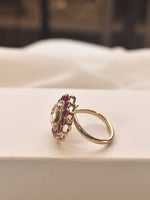 Load image into Gallery viewer, Gold ring with a red gemstone on a white surface