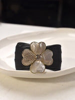 Load image into Gallery viewer, Black headband with a decorative flower clasp