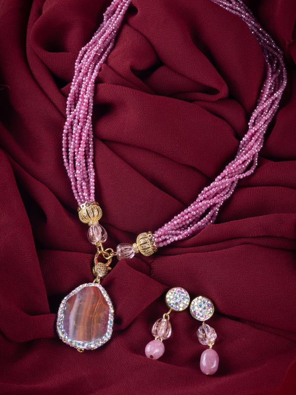 Pink beaded necklace with a large teardrop shaped pink stone pendant