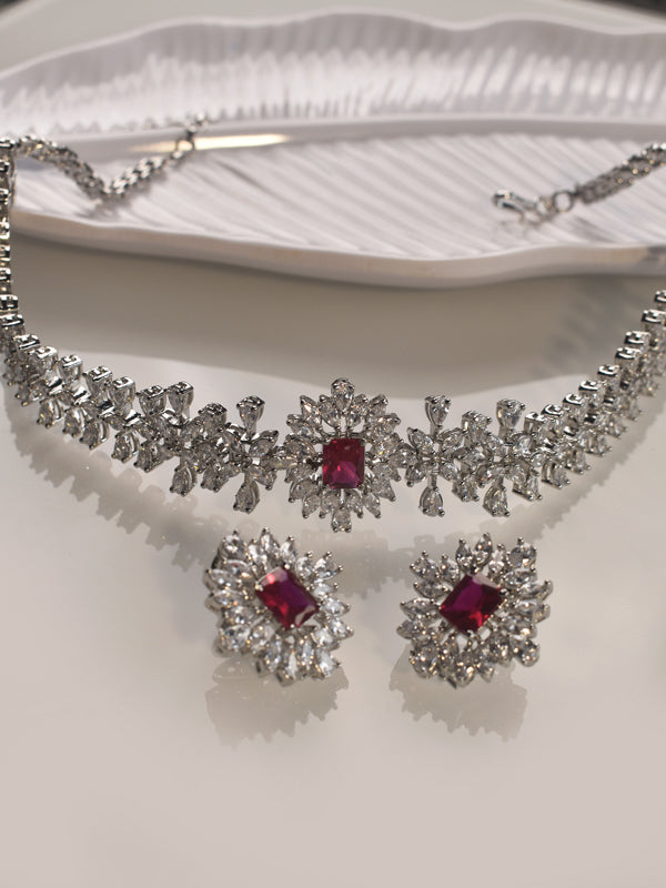 Jewelry set with necklace and earrings featuring red stones 