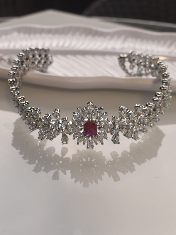 Silver necklace with a red gemstone on 