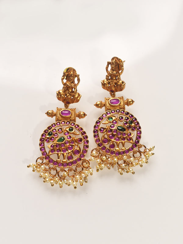 Gold earrings with purple and green stones 
