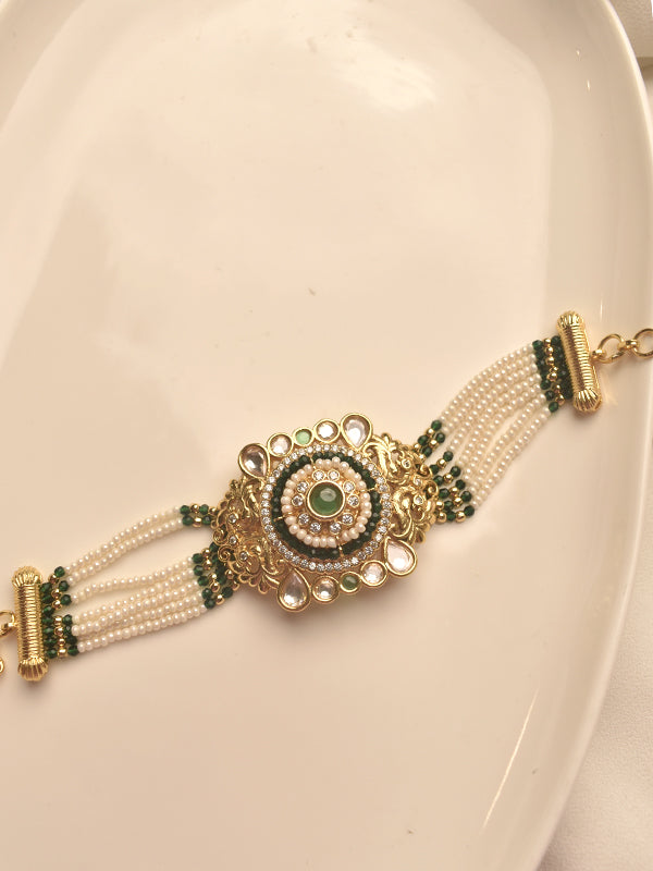 Decorative bracelet with gold, green, and pearl elements