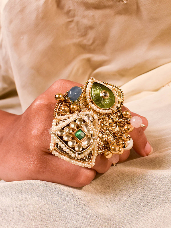 Golden ring with green and blue gemstones 