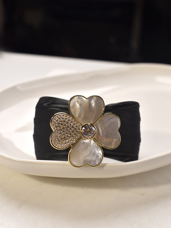 Black headband with a decorative flower clasp 