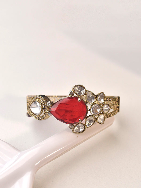 Bracelet with a red gemstone and gold accents 