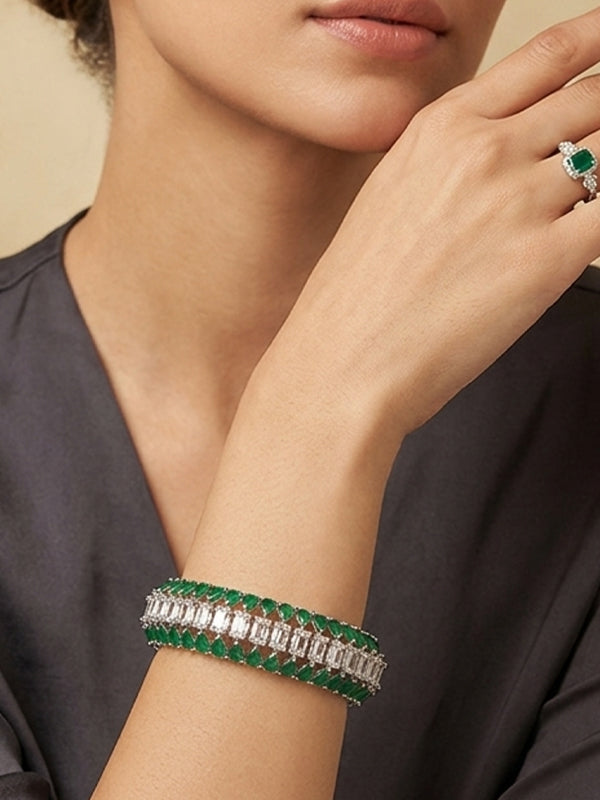 Double strand bracelet with green emerald cut stones and silver toned baguette stones