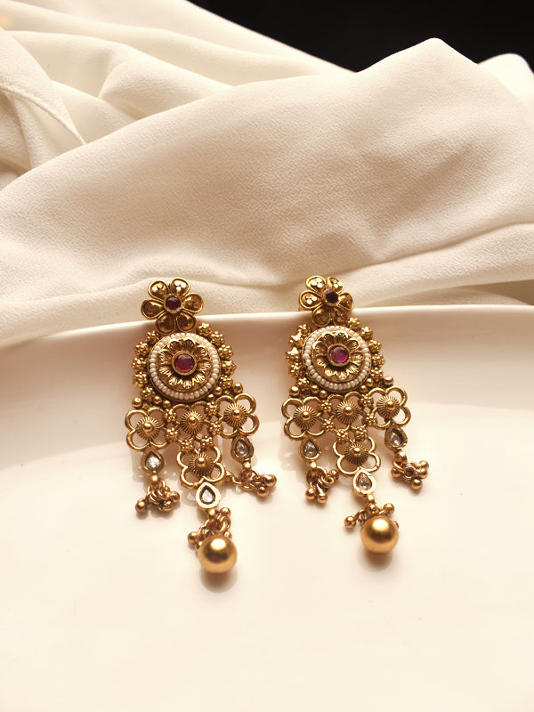 Gold earrings with red gemstones