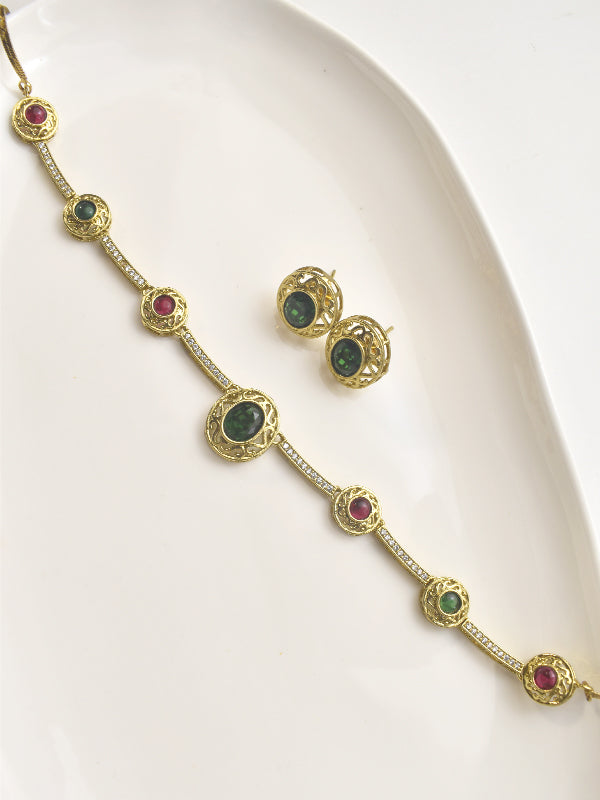 Gold necklace and earrings with gemstones 