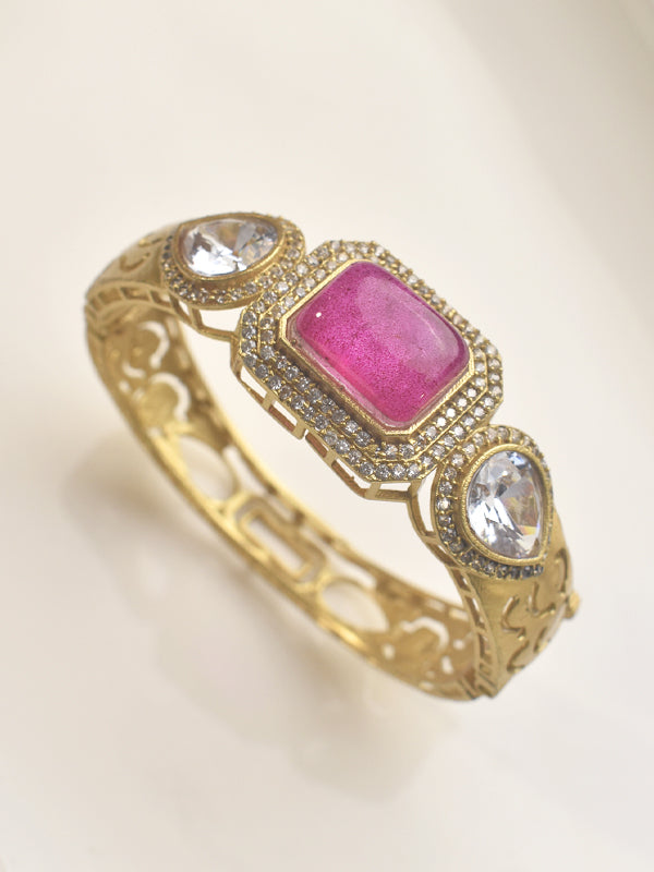 Golden bracelet with pink stone and clear stones