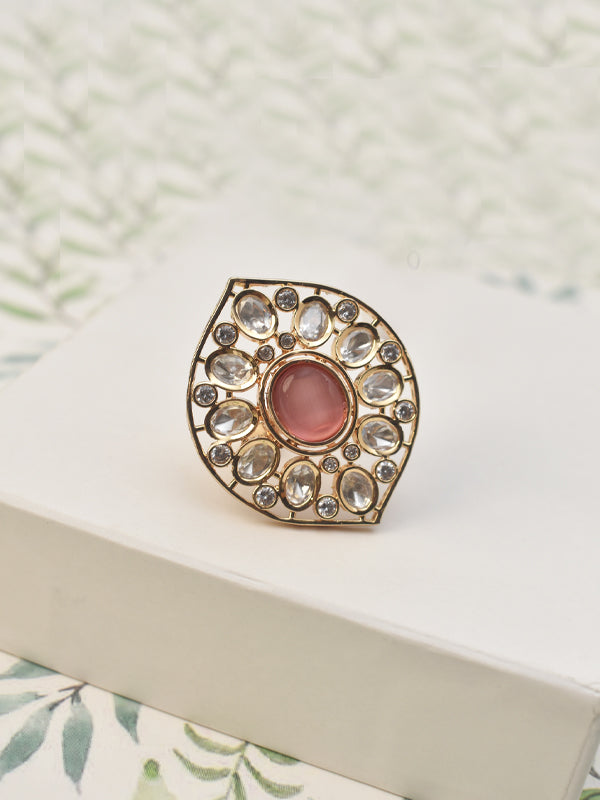 Golden polish ring with a large pink gemstone