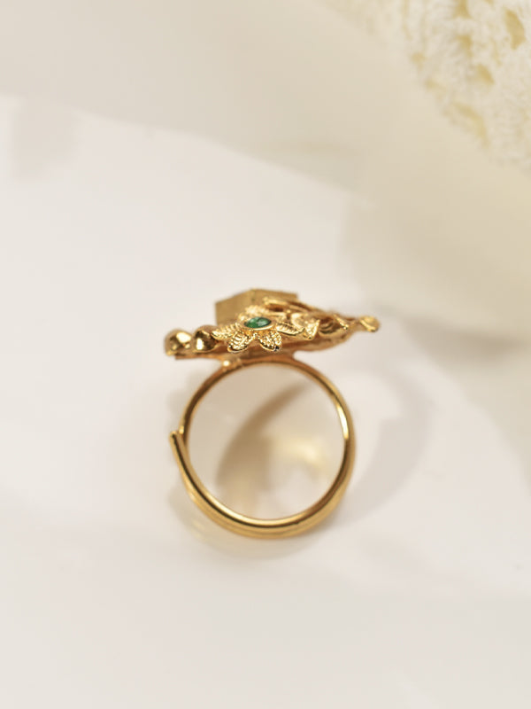 Golden Ring with Intricate Design and Green Gemstone 