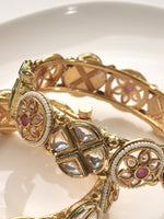 Load image into Gallery viewer, Golden bracelet with intricate designs and gemstones 
