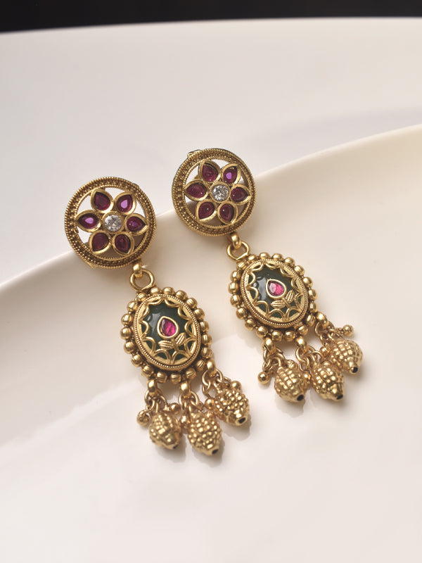 Golden earrings with floral designs and gemstones 