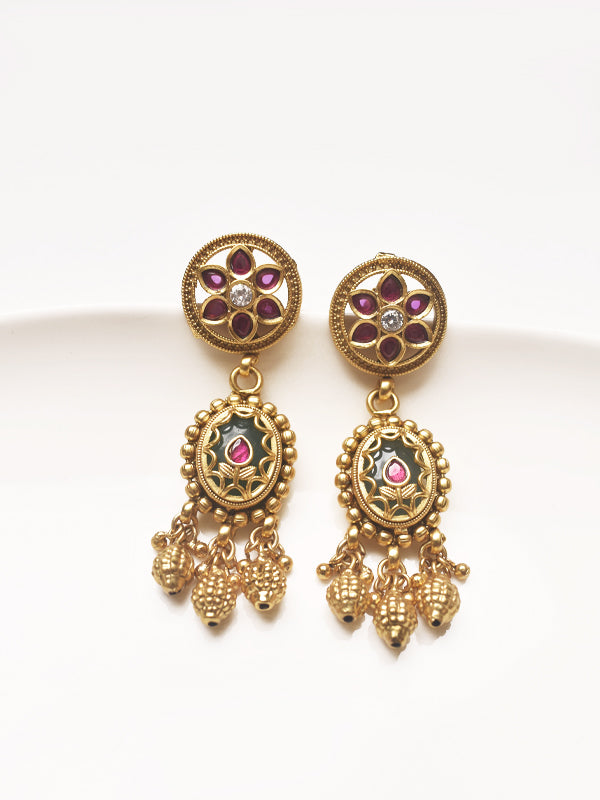 Golden earrings with floral designs and gemstones 