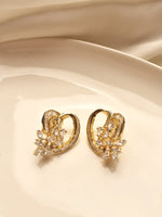 Load image into Gallery viewer, Golden hoop earrings with floral designs 
