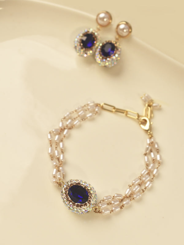 Jewelry set with bracelet and earrings featuring blue gemstones 