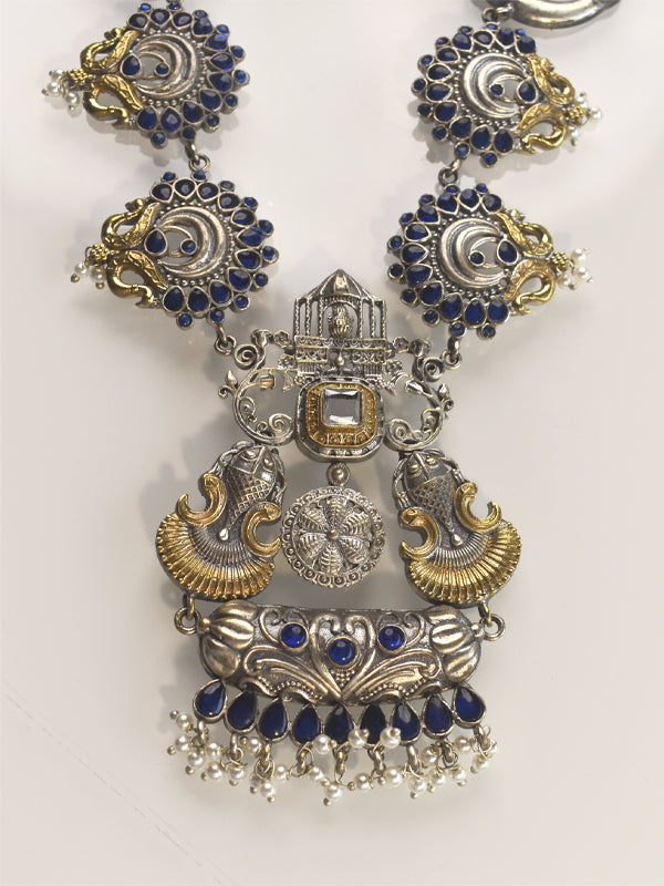 Ornate necklace with blue stones and gold accents 