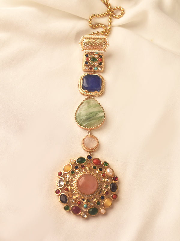Decorative necklace with multicolored stones on a beige background