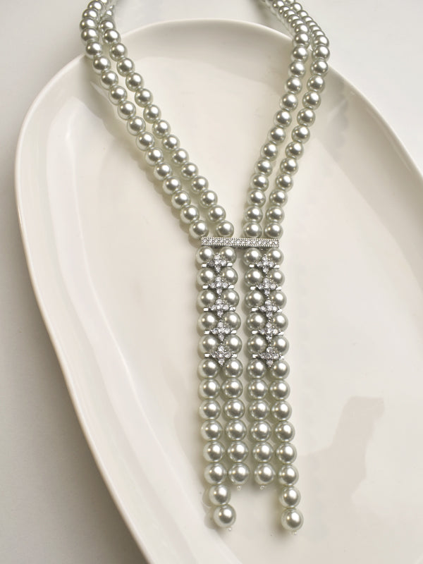 Multiple strands of pearls on a white Stone