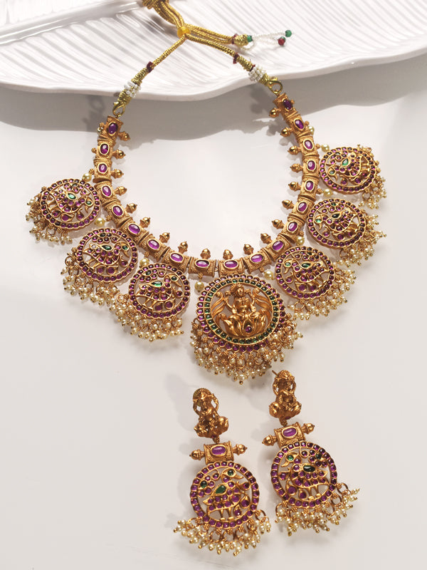 Ornate gold necklace with gemstones o