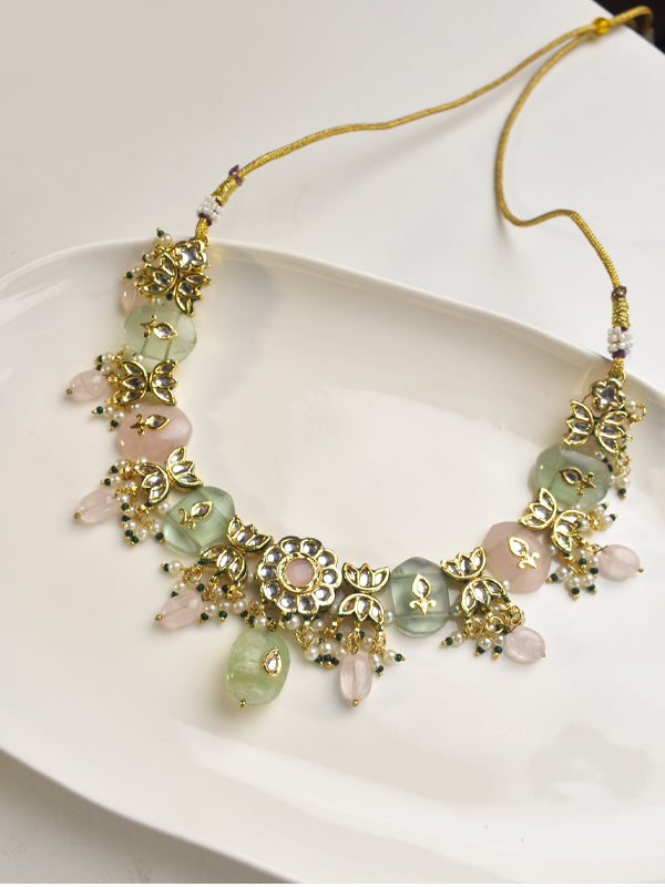 Necklace with gold accents and green and pink beads 