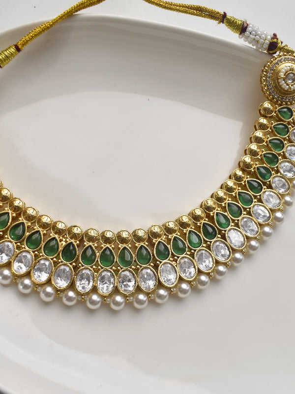 Ornate necklace with green stones, pearls, and golden accents 