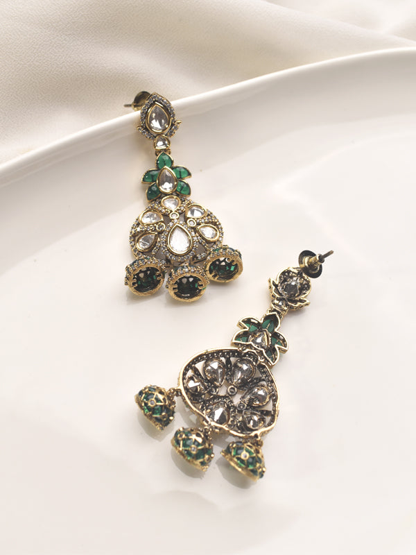 Ornate earrings with green gemstones 