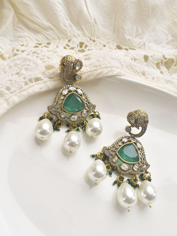 Ornate earrings with green gemstones and pearl like beads 