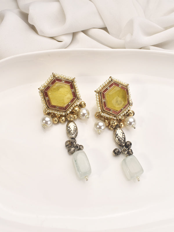 Ornate earrings with yellow gemstones and pearl like elements 