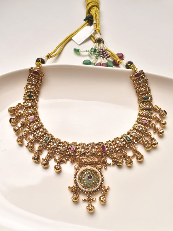 Ornate gold necklace with colorful stones 