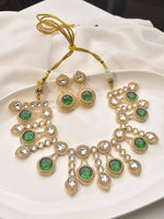 Load image into Gallery viewer, Ornate gold necklace with green gemstones 
