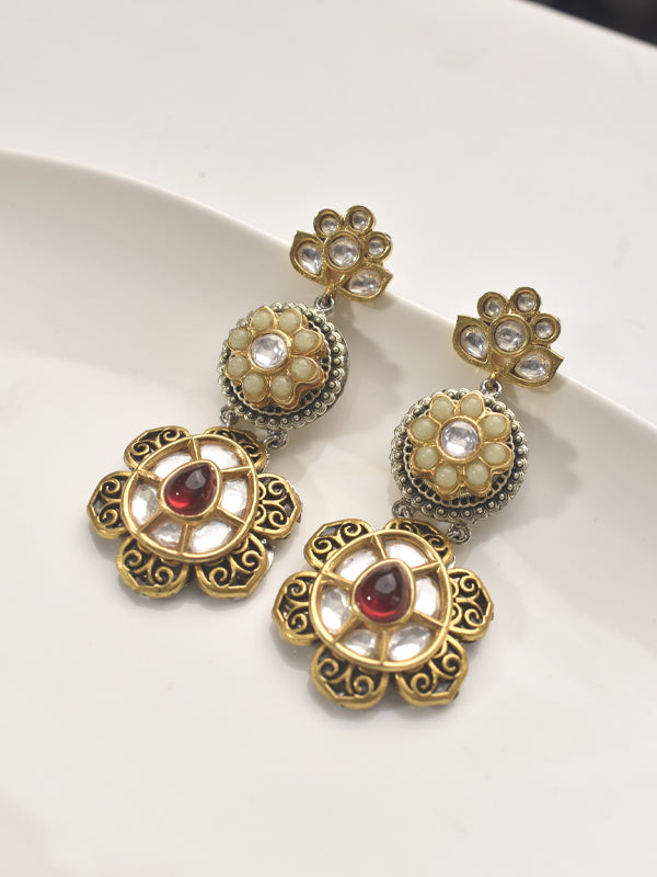 Ornate gold earrings with red stones 