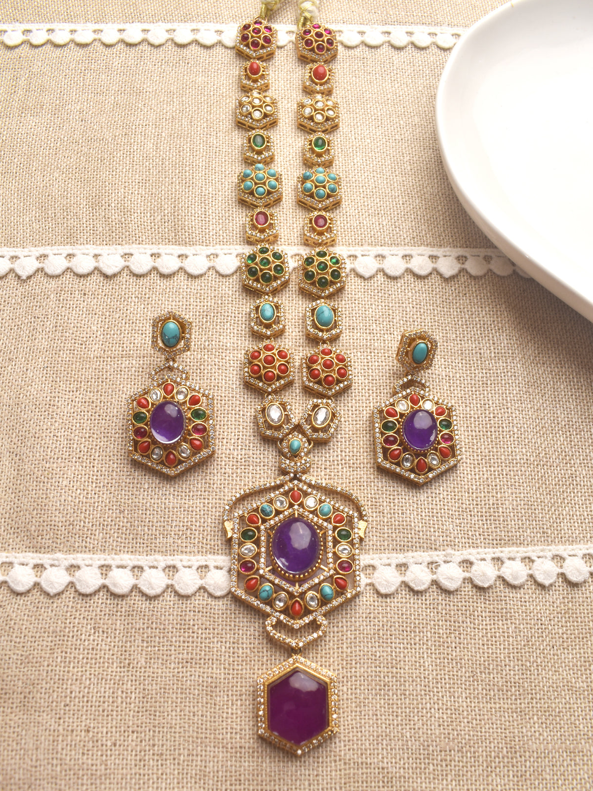 Ornate necklace and earrings set with colorful stones 