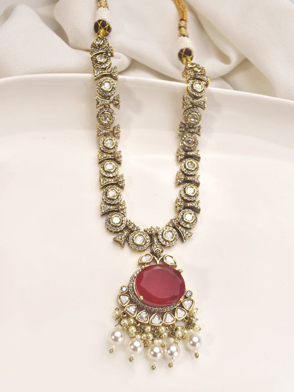 Ornate necklace with a pink central stone 