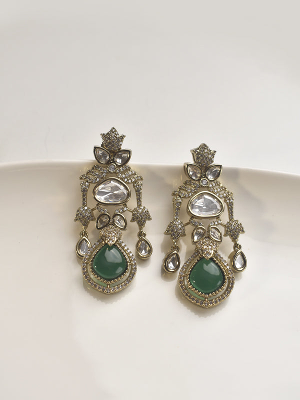 Pair of ornate earrings with green gemstones 