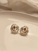 Load image into Gallery viewer, Pair of gold earrings with red gemstones 
