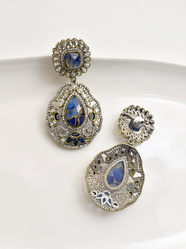 Pair of ornate earrings with blue gemstones 