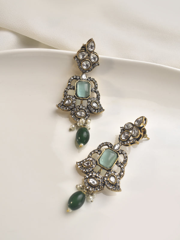 Pair of ornate earrings with green gemstones 