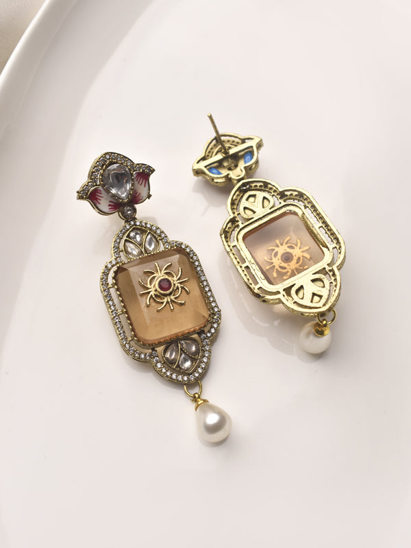 Pair of ornate earrings with intricate designs 