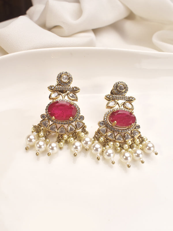 Pair of ornate earrings with pink gemstones and pearl-like elements 