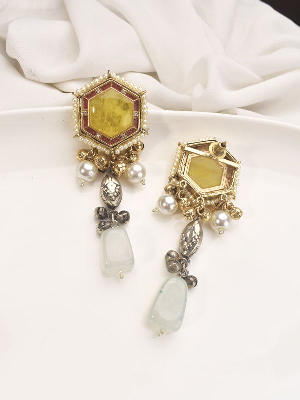 Pair of ornate earrings with yellow gemstones 