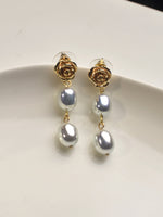 Load image into Gallery viewer, Pearl earrings with gold rose-shaped tops 
