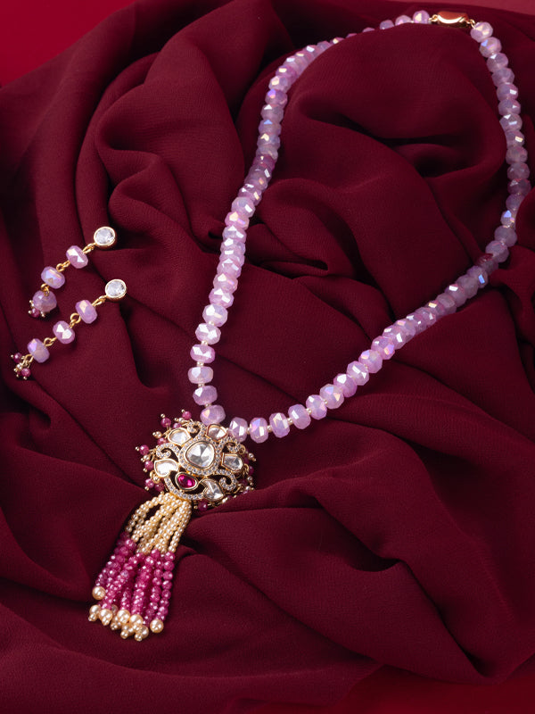 Pink beaded necklace with a gold toned ornate pendant