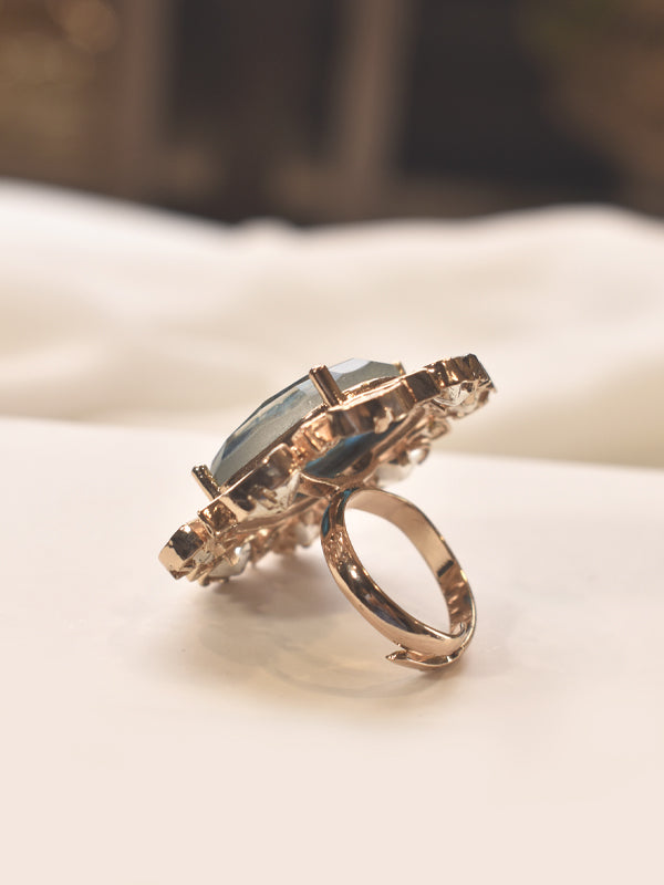 Rose gold polish ring with a large blue gemstone 