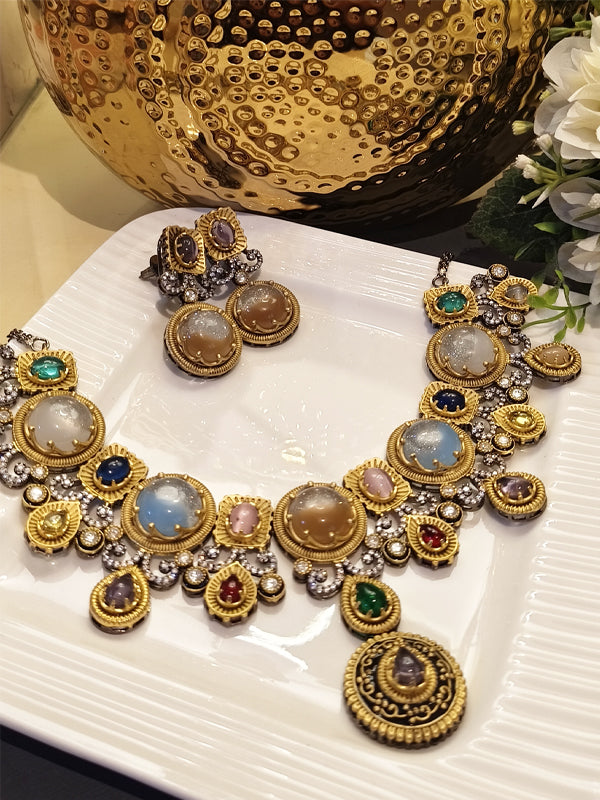 Golden necklace and earrings with stones