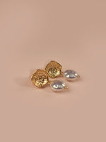 Load image into Gallery viewer,  Stud Earrings with three silver-toned oval stud earrings, arranged on a solid warm beige background.
