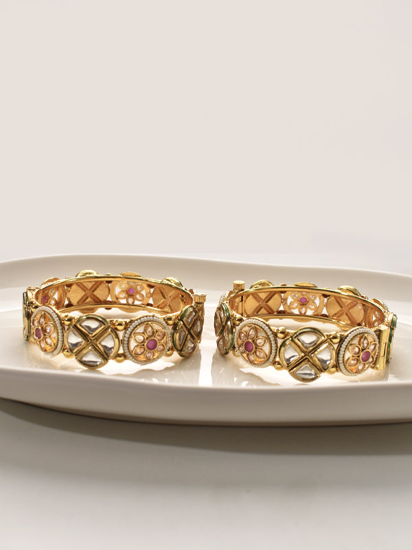 Two golden bracelets with intricate designs